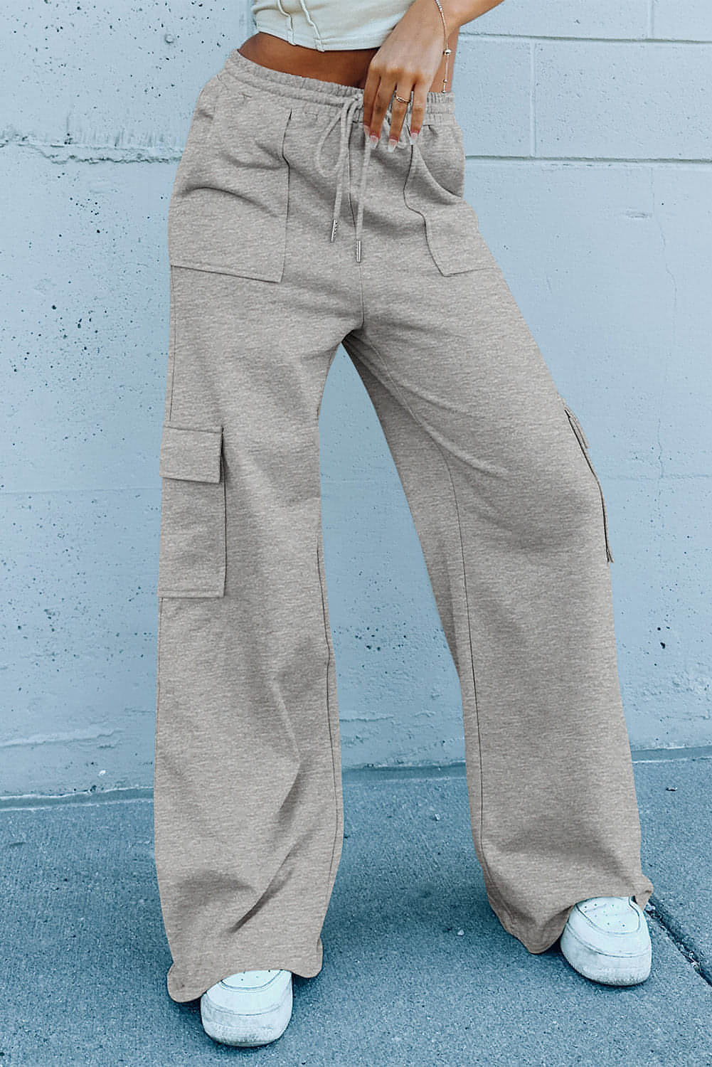 Pantalones de entrenamiento de cintura alta, pierna ancha y múltiples bolsillos con cordones en color gris claro