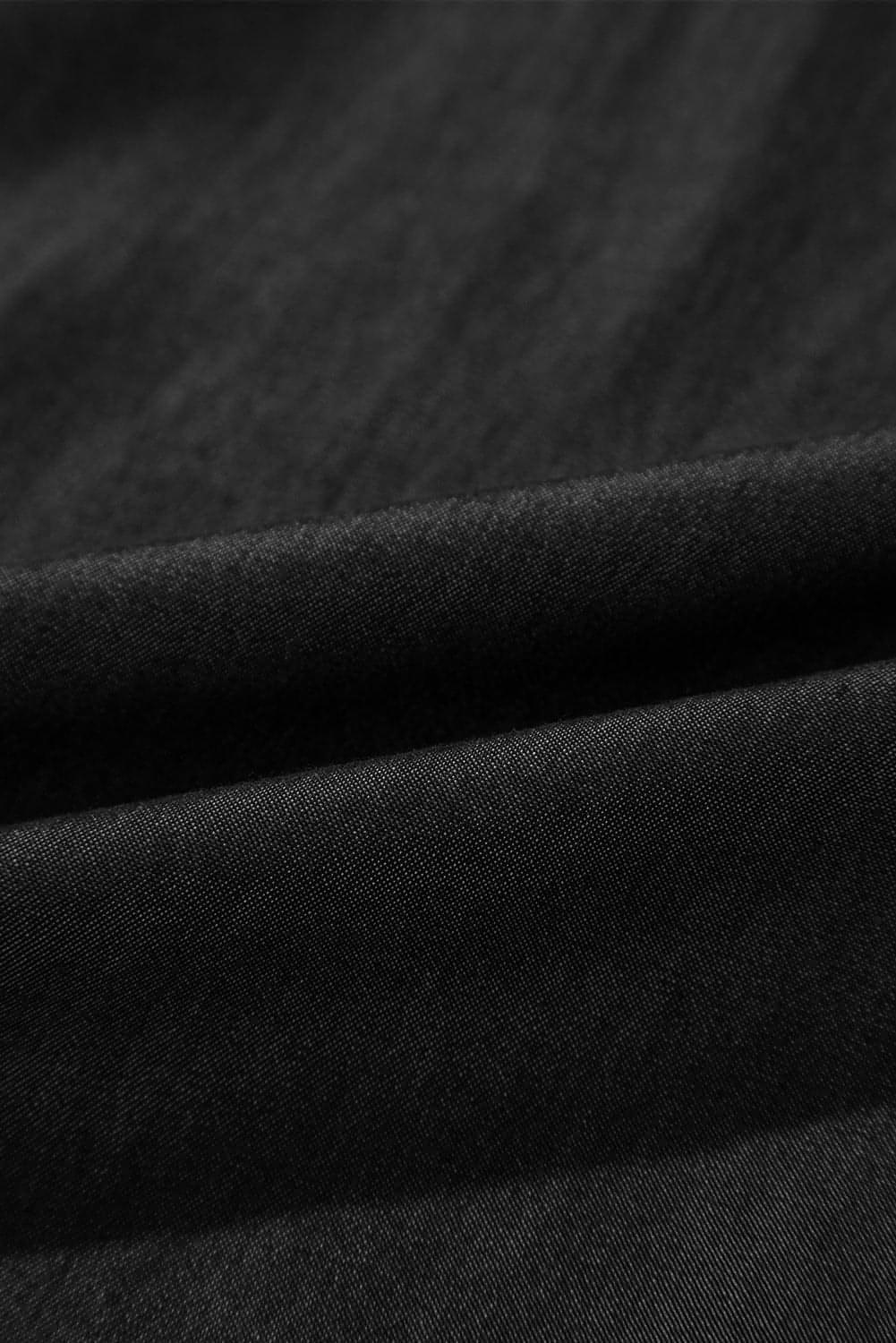 Jean noir smocké taille haute à jambes larges et poches latérales
